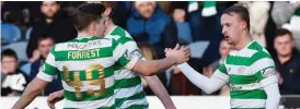  ??  ?? Celtic players celebrate after scoring a goal in this file photo.