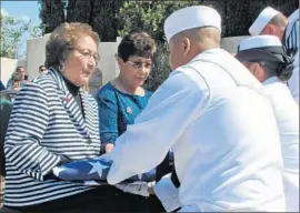  ??  ?? HELEN CHAVEZ accepts an American f lag from the U.S. Navy during a ceremony honoring her late husband, Cesar Chavez, for his military service.