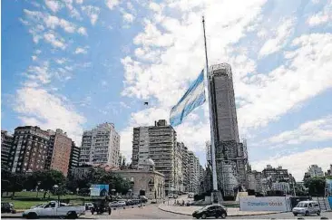 ?? [AP PHOTO] ?? The Argentine national flag flies half staff Wednesday at the “Monumento a la bandera,” in Rosario, Argentina. Argentina is mourning five victims of the bike path attack near the World Trade Center who were part of a group of friends celebratin­g the...