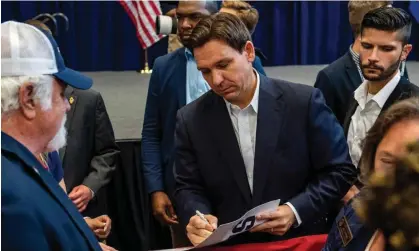  ?? Joseph Prezioso/AFP/Getty Images ?? Ron DeSantis signs autographs after speaking during a campaign stop in Manchester, New Hampshire, earlier this month. Photograph: