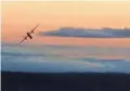  ?? JOHN WAULDRON VIA AFP/GETTY IMAGES ?? A stolen airplane makes an unlikely upside-down aerial loop over Puget Sound before crashing Friday night.