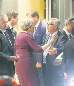  ?? — Reuters photo ?? May is greeted by Juncker while leaving the European Commission headquarte­rs after a meeting in Brussels, Belgium.