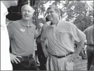  ?? Arkansas Democrat-Gazette/STEPHEN B. THORNTON ?? Gubernator­ial candidates Asa Hutchinson (left) and Mike Ross chat with another candidate before the Politicall­y Correct Watermelon Eating Contest on Saturday morning.