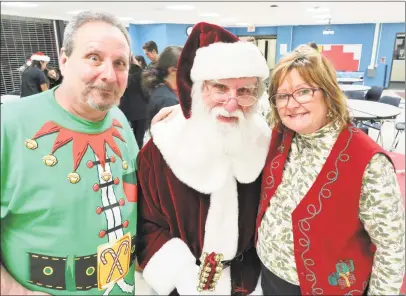  ?? Marcia Sacco photo ?? The town of Cromwell and high school Student Council organized the annual Santa’s workshop this week for local children. Here, from left, are magician Steve Wronker, St. Nicholas and Nancy Whitehead, who is known as “Noodles.”