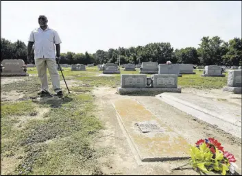  ?? Gerry Broome The Associated Press ?? Larry Monk stands where his father was buried beside his mother’s grave July 11 at Elmwood Cemetery in Goldsboro, N.C. Flooding unearthed his father’s vault and a number of other graves at the cemetery in 2016 following Hurricane Matthew.