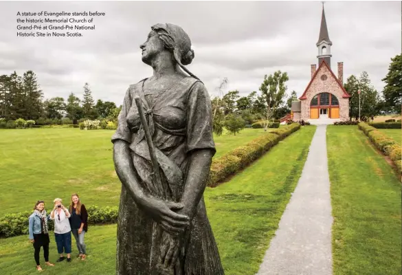  ??  ?? A statue of Evangeline stands before the historic Memorial Church of Grand-Pré at Grand-Pré National Historic Site in Nova Scotia.