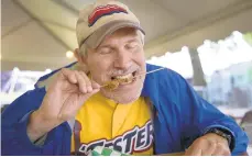 ?? MORNING CALL FILE PHOTO ?? Bill White became known in part for his annual effort to eat his way through Musikfest, including trying fried cajun gator from the Crave Cajun food stand last year.