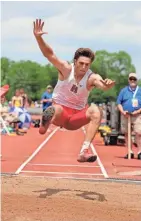  ?? RICK WOOD / MILWAUKEE JOURNAL SENTINEL ?? Ty Olejnik of Sussex Hamilton soars 24.05.75 feet to win the Division 1 long jump.