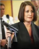  ?? KEVIN HOFFMAN - THE MERCURY ?? In this file photo, former Montco D.A. Risa Vetri Ferman holds up a TEC-9 machine gun.