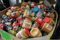  ?? SUBMITTED PHOTO ?? DNB employees and customers donated more than 1,500 pounds of peanut butter and jelly during a collection drive in May with the goal of battling childhood hunger. The jars of peanut butter and jelly were donated to the Chester County Food Bank.