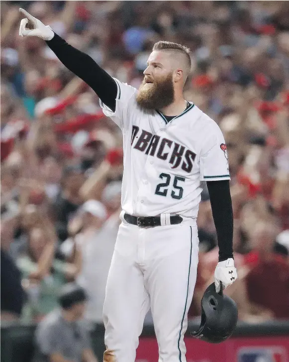  ?? — THE ASSOCIATED PRESS ?? Arizona Diamondbac­ks relief pitcher Archie Bradley celebrates his two-run triple against the Colorado Rockies during the seventh inning of the National League wild-card playoff game on Wednesday night in Phoenix, which the Diamondbac­ks won 11-8.