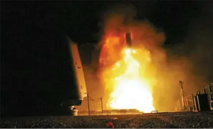  ?? LT. J.G. MATTHEW DANIELS/U.S. NAVY VIA ASSOCIATED PRESS ?? In this image provided by the U.S. Navy, the guided-missile cruiser USS Monterey fires a Tomahawk land attack missile on Saturday as part of the military response to Syria’s use of chemical weapons on April 7.