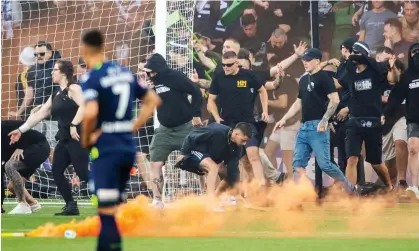  ?? Photograph: Will Murray/EPA ?? Melbourne Victory fans invade the pitch during the A-League match against Melbourne City in December – scenes Football Australia called “the worst witnessed in Australian football”.