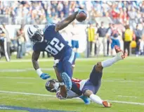  ?? Associated Press ?? Tennessee Titans tight end Delanie Walker (82) drags Houston Texans cornerback Kevin Johnson (30) into the end zone as Walker scores a touchdown on a 24-yard pass in the second half of an NFL football game Sunday in Nashville, Tenn.