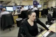  ?? MARK LENNIHAN — THE ASSOCIATED PRESS ?? Traders work on the Mizuho Americas trading floor in New York.