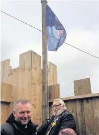  ??  ?? Mayor of Bridgend County Borough Reg Jenkins raises the flag at Tynyrheol Primary School’s castle