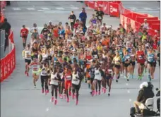  ?? Chicago Tribune/tns ?? Runners start the Bank of America Chicago Marathon on Columbus Drive on Sunday.