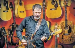  ?? GABRIELA CAMPOS/THE NEW MEXICAN ?? Sean Healen plays his custom-made guitar, called Zenith, at Borrego’s Guitars and Music Supply Co. on Friday. Healen will soon begin on his newest project,Healen’s New 52, a weekly show on KBAC-FM 98.1 featuring a new original song each week for 52 weeks.