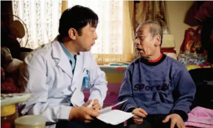  ??  ?? April 3, 2018: Zhao Sheng, a physician at Erqibei Community Healthcare Center in Fengtai District, Beijing, conducts a physical examinatio­n of a local resident. VCG