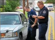  ?? TOM KELLY IV — FOR DIGITAL FIRST MEDIA ?? Police examine the car involved in the accident July 20 near the intersecti­on of Beech and Manatawny streets.