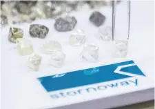  ?? POSTMEDIA FILES ?? Uncut diamonds are displayed at Stornoway Diamond’s Renard diamond mine in Quebec. The Quebec-based firm says downward pressure on the market price for rough diamonds has been a key reason that it fell short in generating positive free cash flow in 2019.