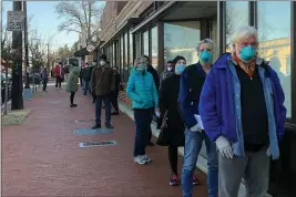  ?? CAROLE FELDMAN — THE ASSOCIATED PRESS ?? People 65and older wait outside the Hattie Holmes Senior Wellness Center in Washington on Jan. 12to get a coronaviru­s vaccine. The nation’s capital expanded access to the vaccine to older residents a day earlier and demand quickly exceeded supply.