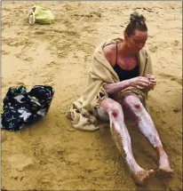  ??  ?? Pleasanton’s Catherine Breed sits on San Carlos Beach in Monterey on Tuesday after she became the fifth female to successful­ly swim across the Monterey Bay.