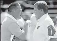  ?? AP file photo ?? Coach Jim McElwain (right) and the No. 24 Florida Gators could start a season 0-2 for the first time since 1971 if they lose to Butch Jones and the No. 23 Tennessee Volunteers today in Gainesvill­e, Fla.