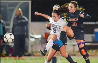  ?? SARAH GORDON/THE DAY ?? Montville’s Olivia Meehan (10) kicks the ball past Ellington’s Emily Gorman (5) during Wednesday night’s Class M state girls’ soccer tournament second-round game at Montville. Ellington won 1-0.