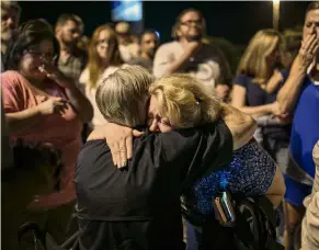  ?? — AP ?? Stay strong: Texas Governor Greg Abbott consoling Ann Montgomery, a Sunday school teacher, at First Baptist Church in Sutherland Springs during a candleligh­t vigil for the victims.