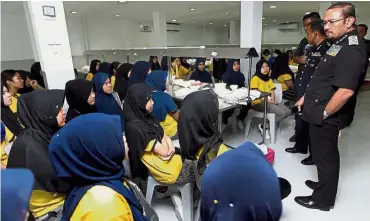  ??  ?? Nest of inequity: Mustafar (right) talking to some of the Indonesian workers at the bird’s nest processing centre during a raid in Klang.