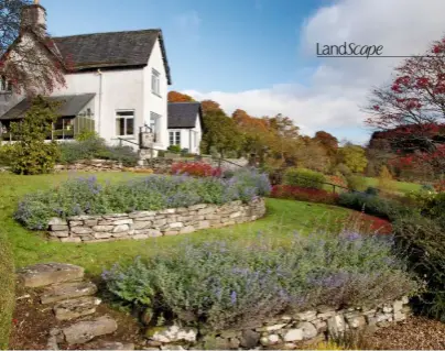  ??  ?? Sally and Donald Crystal sit in their sloping terraced garden at Little Tombuie in Perthshire. Right: The terraces are supported by dry stone dykes planted with nepeta. A stone cheese press sits to the front of the house. ›