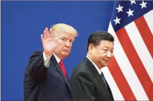  ?? NICOLAS ASFOURI/AFP ?? US President Donald Trump and China’s President Xi Jinping leave a business leaders event at the Great Hall of the People in Beijing on November 9.