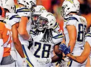  ?? [AP PHOTO] ?? Los Angeles Chargers running back Melvin Gordon, center, celebrates his touchdown with teammates during Monday night’s late game against the Denver Broncos.