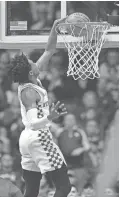  ?? GEORGE WALKER IV / THE TENNESSEAN ?? Kentucky guard De'Aaron Fox (0) slams two points early in the first half of the SEC Men's Championsh­ip at Bridgeston­e Arena on March 12 in Nashville, Tenn.