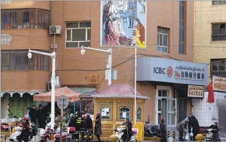  ?? Ng Han Guan Associated Press ?? CHINA IS poised to overtake Britain as the world’s most monitored country. Above, security cameras in the Xinjiang city of Kashgar.