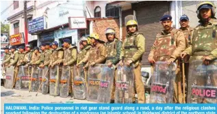  ?? -- AFP ?? HALDWANI, India: Police personnel in riot gear stand guard along a road, a day after the religious clashes sparked following the destructio­n of a madrassa (an Islamic school) in Haldwani district of the northern state of Uttarakhan­d on February 9, 2024.