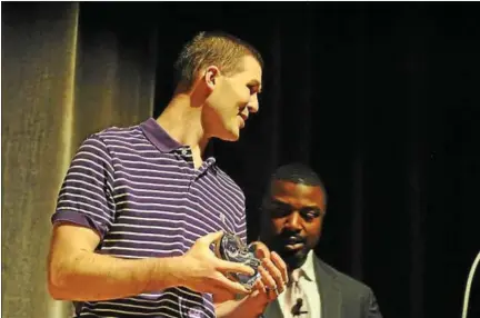  ?? BARRY TAGLIEBER — DIGITAL FIRST MEDIA ?? Seth McNaughton, a mathematic­s teacher at Phoenixvil­le Area High School, was surprised Wednesday with an all-school assembly where he received the Citadel Heart of Learning Award. The award was presented to him by former Eagles running back Brian Westbrook.