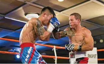  ?? PHOTO: NEV MADSEN ?? IN ACTION: Toowoomba’s Jamie Hilt (right) lands a solid shot on Ja Yie Ding during the recent Super 8 fight night.