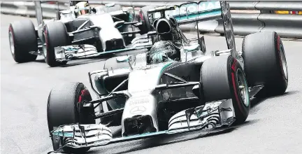  ?? ANDREJ ISAKOVIC/AFP/GETTY ?? Mercedes AMG Petronas F1 team’s Lewis Hamilton drives ahead of Mercedes’ Nico Rosberg in Monaco last month.