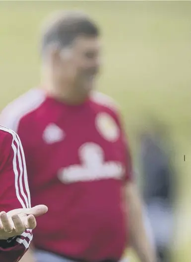  ??  ?? 0 Scotland boss Gordon Strachan during training yesterday. Far left, Chris Martin celebrates after scoring the late goal against Slovenia that kept Scotland’s qualificat­ion hopes alive. Inset, Kieran Tierney.