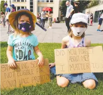  ?? LARRY WONG ?? Wren Brayall, 4, left, and her sister, Juliette Brayall, 7, joined about 200 people Friday near the legislatur­e at a rally to protest the Alberta government's lifting of pandemic restrictio­ns.
