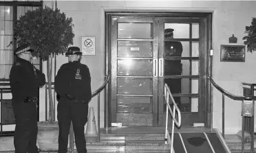  ?? LEFTERIS PITARAKIS/ THE ASSOCIATED PRESS ?? Police officers stand guard outside the King Edward VII hospital in central London on Friday.