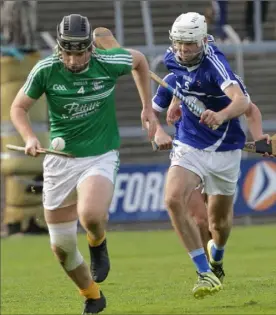  ??  ?? Eoin Molloy of Naomh Eanna bursts out of defence as Ciarán Hourihane gives chase.