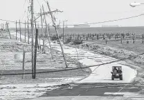  ?? Staff file photo ?? A crew drives out of the Texas City Dike, where all the businesses were destroyed and the road damaged by Hurricane Ike, in 2008.