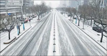  ??  ?? WINTER OF DISCONTENT: An empty street is seen in Beijing on Wednesday.
AFP