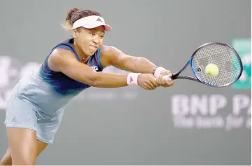  ??  ?? Naomi Osaka of Japan plays a backhand against Kristina Mladenovic of France during their women’s singles second round match on day six of the BNP Paribas Open at the Indian Wells Tennis Garden. — AFP photo