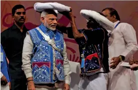  ?? — PRITAM BANDYOPADH­YAY ?? Prime Minister Narendra Modi is offered a traditiona­l turban at the inaugurati­on of the National Tribal Carnival 2016 in New Delhi on Tuesday. At the event, Mr Modi said no one should be allowed to “snatch” the rights of tribals.