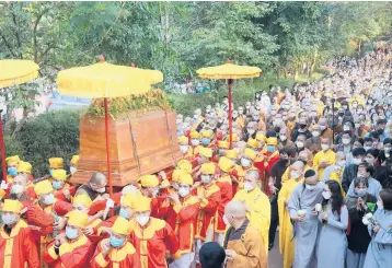  ?? THANH VO/AP ?? Funeral farewell: The coffin of Vietnamese Buddhist monk Thich Nhat Hanh is carried to the street Saturday during his funeral in Hue, Vietnam. The service was held a week after the renowned Zen master died at the age of 95. Nhat Hanh was globally recognized for spreading the practice of mindfulnes­s and socially engaged Buddhism.