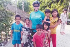  ??  ?? Abi posing with new friends in a village near Long Xuyen in Vietnam.